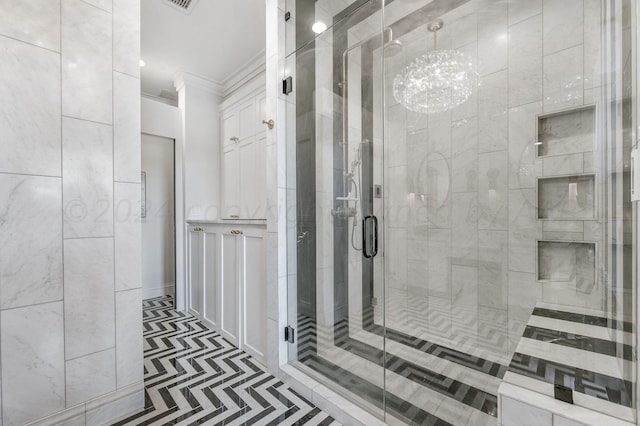 bathroom with ornamental molding and a shower with shower door