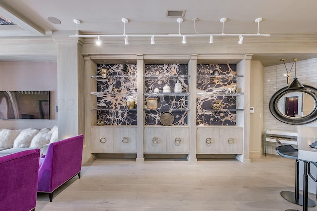 wine room featuring wood-type flooring and track lighting