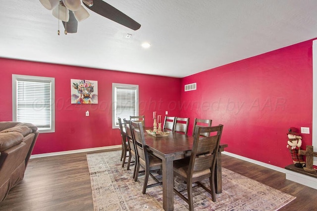 dining space with plenty of natural light, wood finished floors, and visible vents