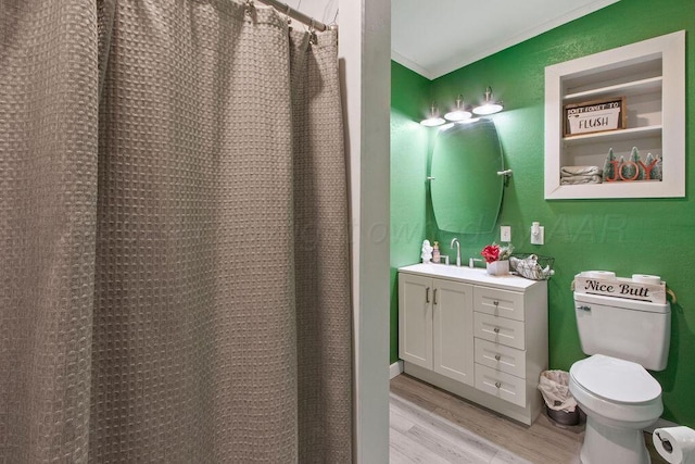 full bathroom with toilet, a shower with curtain, wood finished floors, crown molding, and vanity