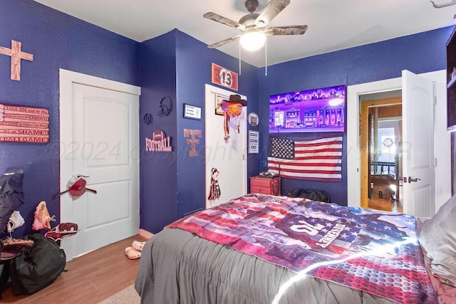 bedroom with wood finished floors and a ceiling fan