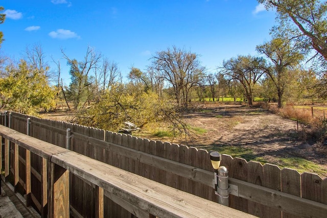 view of yard featuring fence and a rural view