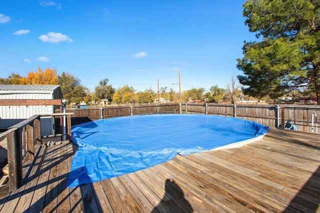 view of swimming pool featuring a fenced in pool, fence, and a wooden deck