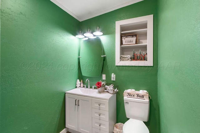 bathroom featuring toilet, ornamental molding, and vanity