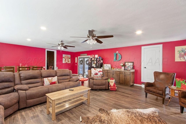 living room featuring recessed lighting, baseboards, and wood finished floors