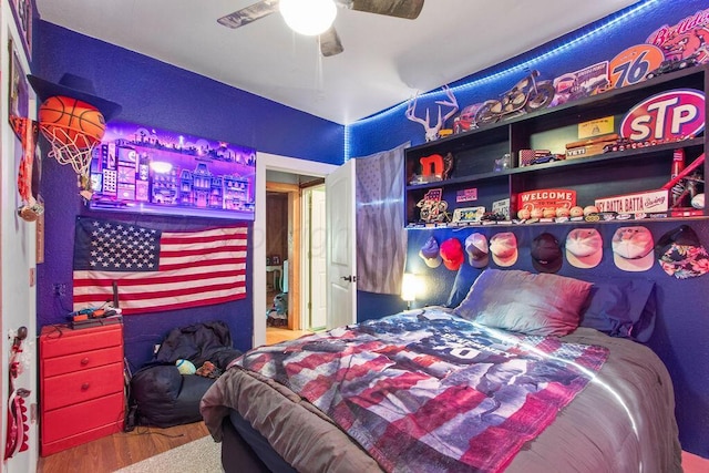 bedroom featuring a ceiling fan and wood finished floors