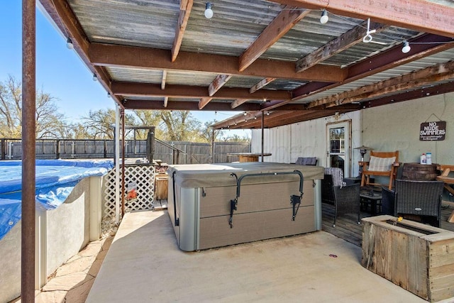 view of patio / terrace with a fenced backyard and a hot tub