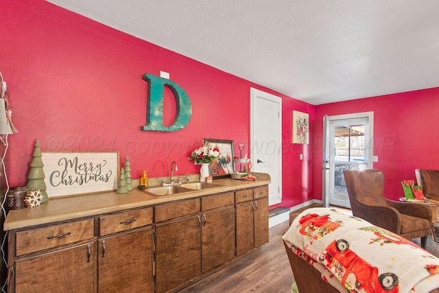 interior space featuring baseboards and wood finished floors