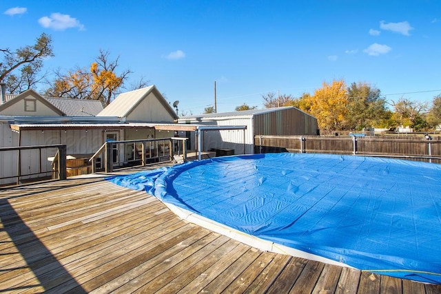 view of swimming pool featuring a fenced in pool, fence, and a wooden deck