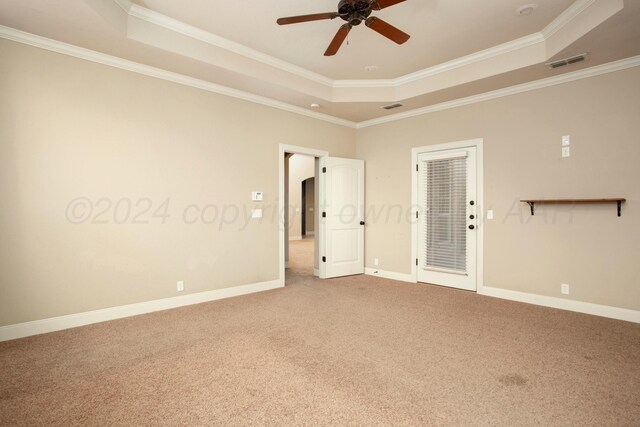 8620 Cortona Dr, Amarillo, TX 79119 - empty room with a raised ceiling, carpet floors, ceiling fan, crown molding, and baseboards