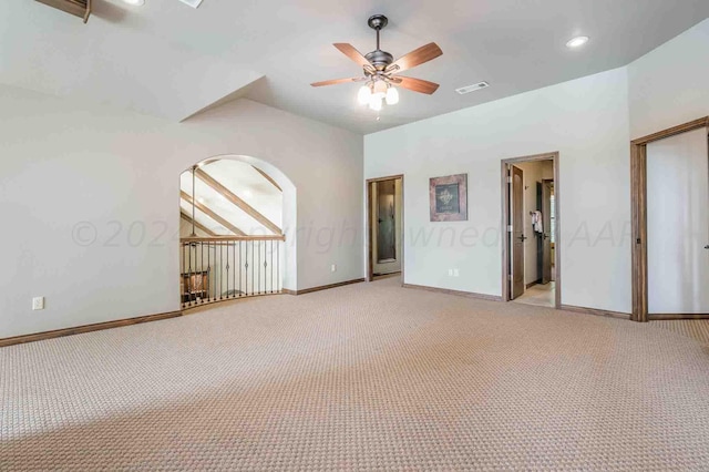 carpeted empty room featuring lofted ceiling and ceiling fan