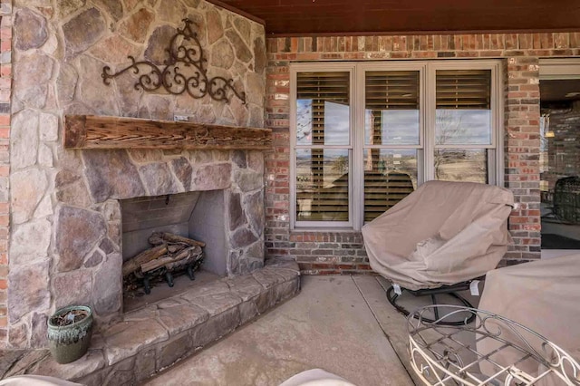 view of patio / terrace featuring an outdoor stone fireplace