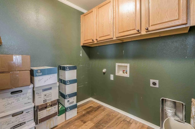 clothes washing area with ornamental molding, hookup for an electric dryer, light wood-type flooring, washer hookup, and cabinets