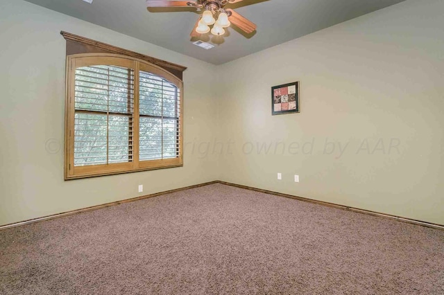 carpeted spare room with ceiling fan