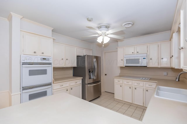 6710 Gainsborough Rd, Amarillo, TX 79106 - kitchen with white appliances, ceiling fan, light countertops, crown molding, and white cabinets