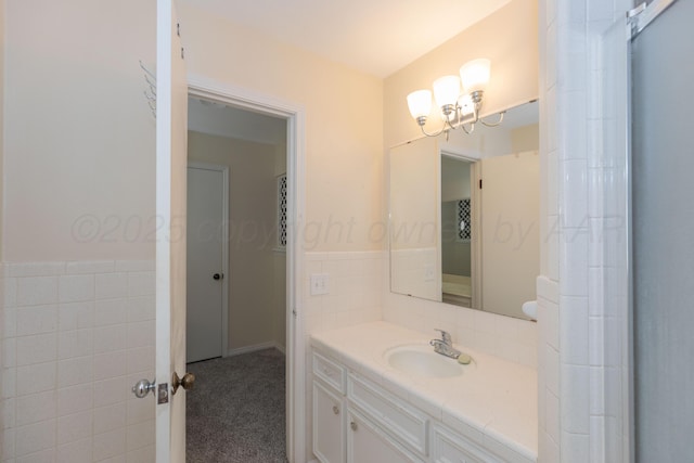 6710 Gainsborough Rd, Amarillo, TX 79106 - bathroom with vanity, tile walls, and a chandelier