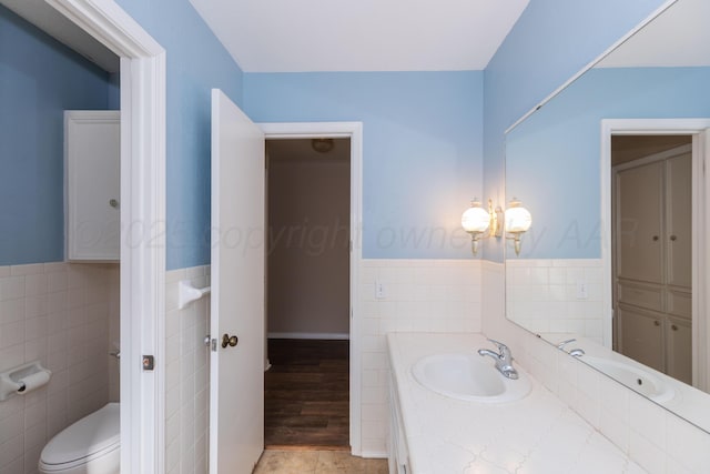 6710 Gainsborough Rd, Amarillo, TX 79106 - bathroom with tile walls, vanity, and wainscoting