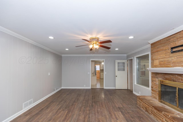 6710 Gainsborough Rd, Amarillo, TX 79106 - unfurnished living room featuring crown molding, a ceiling fan, dark wood-type flooring, a stone fireplace, and recessed lighting