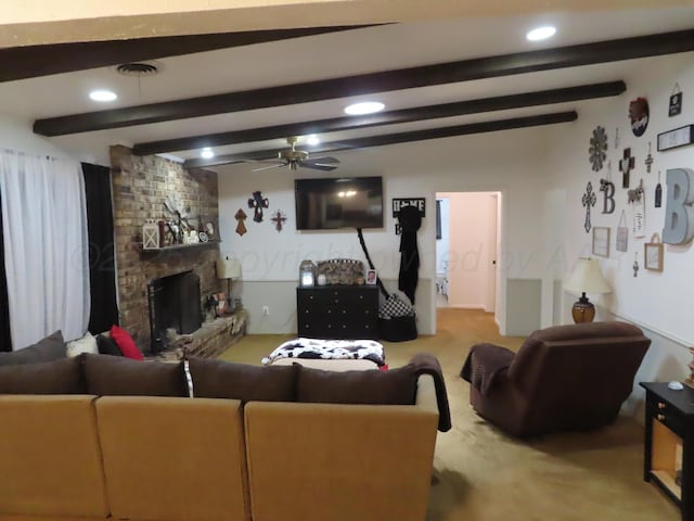 living area featuring carpet, beam ceiling, ceiling fan, a large fireplace, and recessed lighting