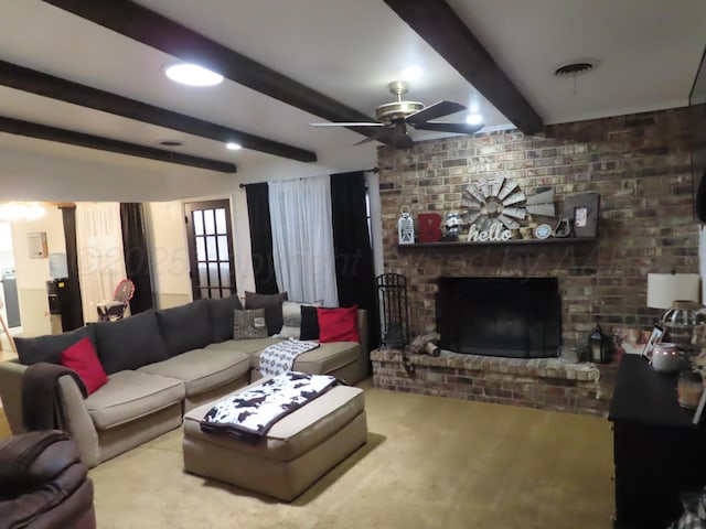 living area with beam ceiling, ceiling fan, and a brick fireplace