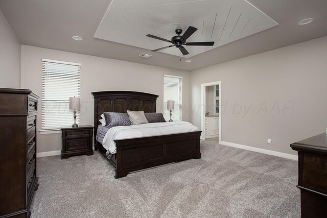 5708 Wesley Rd, Amarillo, TX 79119 - bedroom featuring light colored carpet, a ceiling fan, a tray ceiling, recessed lighting, and ensuite bathroom