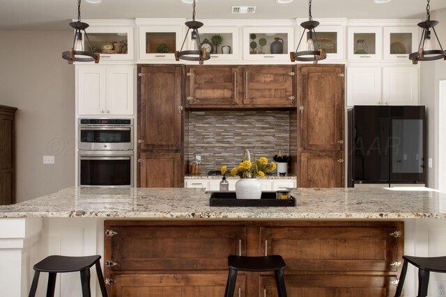 5708 Wesley Rd, Amarillo, TX 79119 - kitchen with double oven, refrigerator, decorative backsplash, glass insert cabinets, and white cabinets