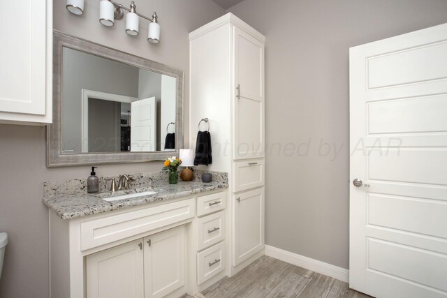 5708 Wesley Rd, Amarillo, TX 79119 - bathroom featuring vanity and wood finished floors