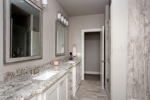 5708 Wesley Rd, Amarillo, TX 79119 - full bath featuring double vanity and wood finished floors
