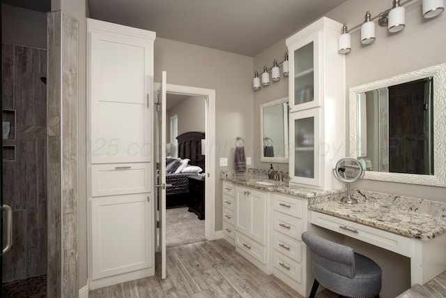 5708 Wesley Rd, Amarillo, TX 79119 - full bath featuring a stall shower, wood finished floors, vanity, and ensuite bath