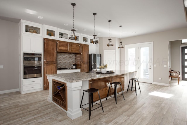 5708 Wesley Rd, Amarillo, TX 79119 - kitchen with decorative backsplash, stainless steel appliances, light wood finished floors, open shelves, and recessed lighting