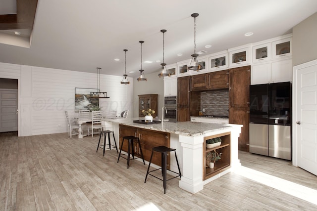 5708 Wesley Rd, Amarillo, TX 79119 - kitchen featuring stainless steel appliances, recessed lighting, light wood finished floors, backsplash, and open shelves