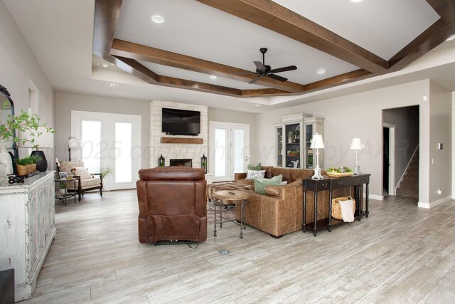 5708 Wesley Rd, Amarillo, TX 79119 - living area with a stone fireplace, ceiling fan, french doors, light wood-style flooring, and stairway