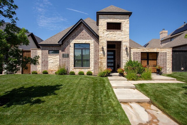 5708 Wesley Rd, Amarillo, TX 79119 - view of front of home featuring a front lawn, roof with shingles, brick siding, and stone siding