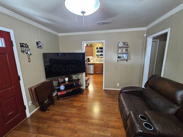 living room featuring ornamental molding, wood finished floors, and visible vents