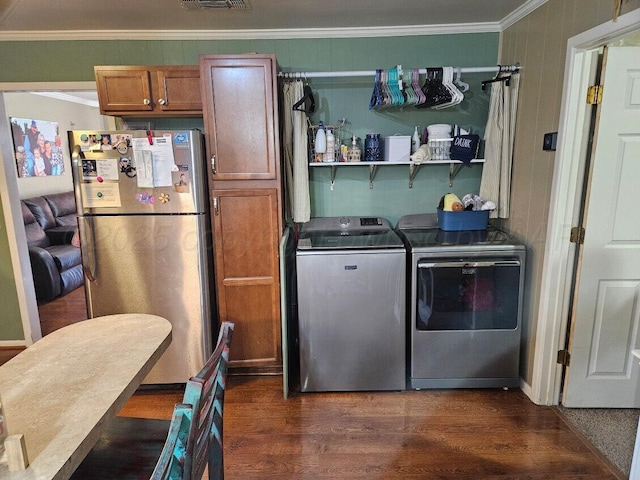laundry area featuring laundry area, visible vents, washing machine and dryer, dark wood-style floors, and ornamental molding