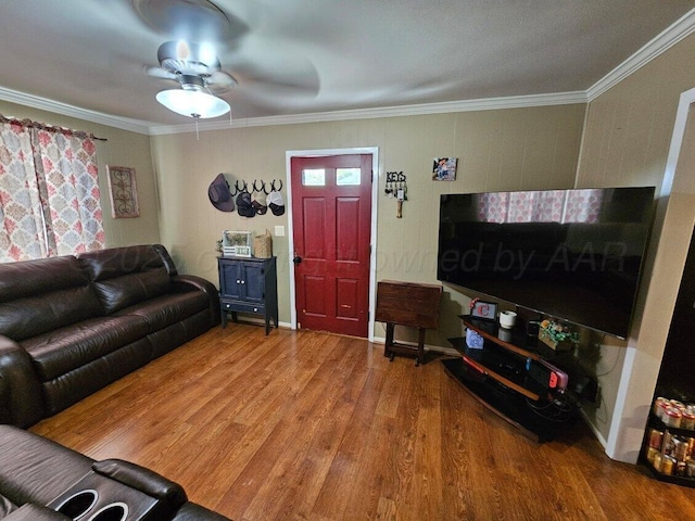 living area featuring ornamental molding, a ceiling fan, and wood finished floors