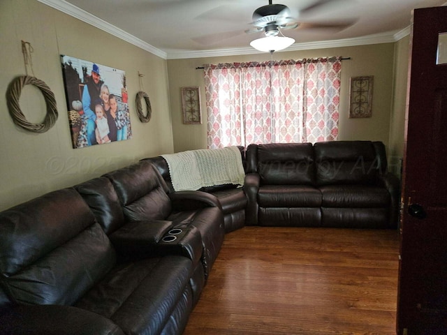 living area with a ceiling fan, ornamental molding, and wood finished floors