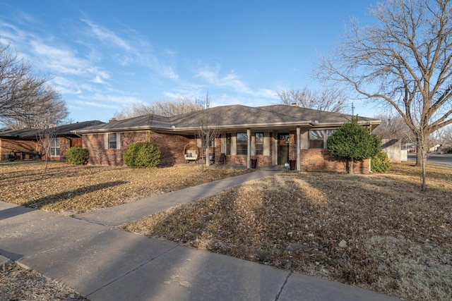 ranch-style house featuring brick siding