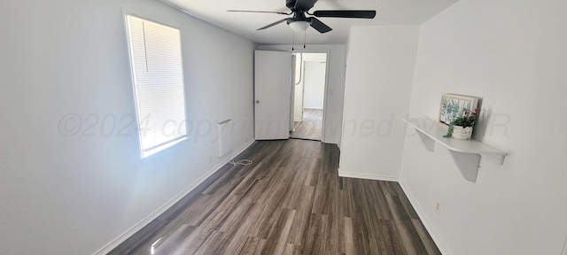 hall with dark hardwood / wood-style floors and a healthy amount of sunlight