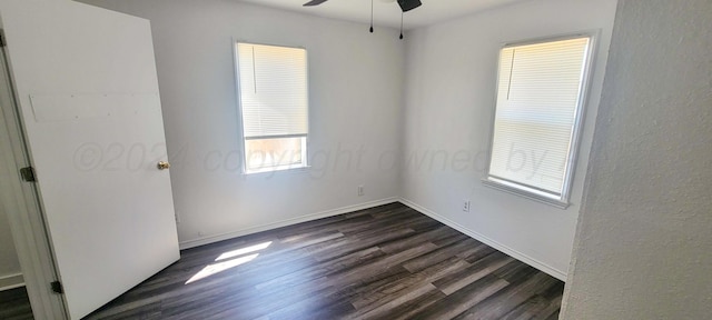 unfurnished room with dark hardwood / wood-style floors and ceiling fan