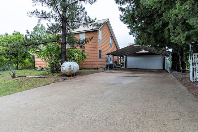view of side of property with an outdoor structure, metal roof, and a garage