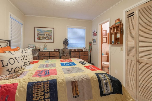 bedroom featuring ornamental molding, connected bathroom, and a closet