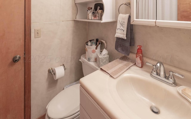 half bathroom with toilet and vanity