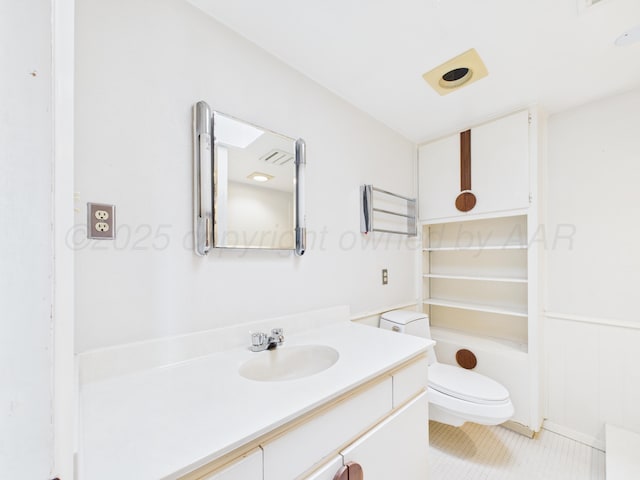 bathroom featuring toilet, vanity, and tile patterned flooring