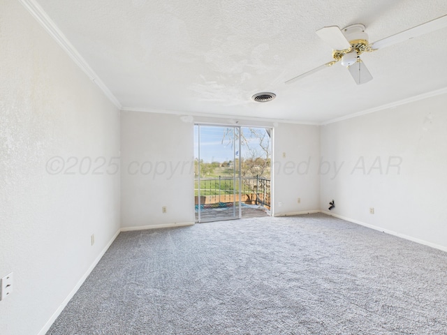 carpeted empty room featuring baseboards, ornamental molding, a textured ceiling, visible vents, and ceiling fan