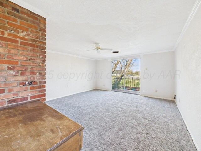 carpeted spare room with crown molding, ceiling fan, and baseboards