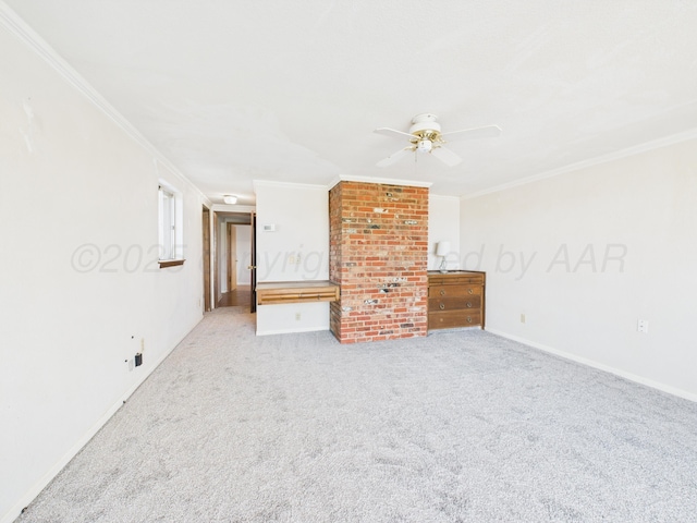 empty room with carpet flooring, baseboards, a ceiling fan, and crown molding