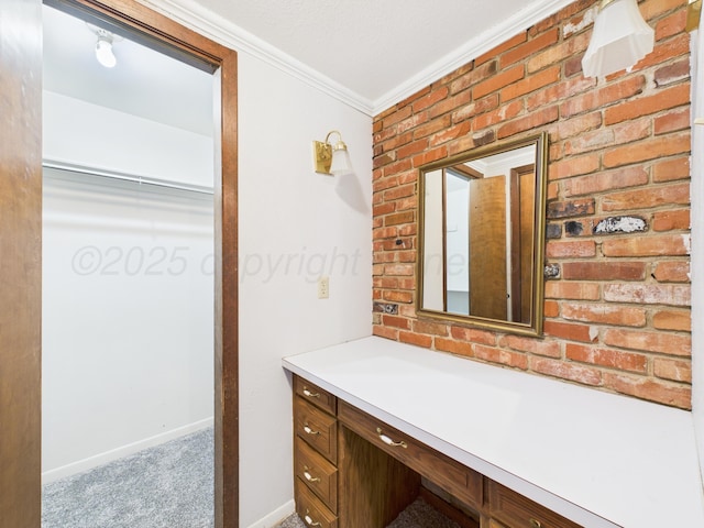 bathroom with brick wall, vanity, baseboards, and ornamental molding