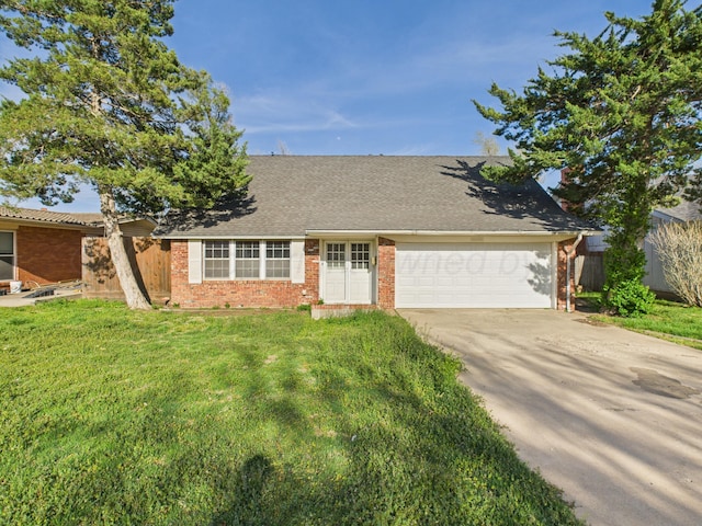 view of front of home with brick siding, a front yard, a garage, and concrete driveway
