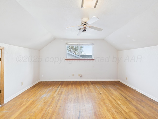 bonus room with light wood-style flooring, baseboards, and lofted ceiling